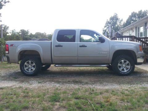 1995 Ford F-150 - This silver GMC Sierra pickup truck is shown from the side. The vehicle appears to be a 2007 model year.