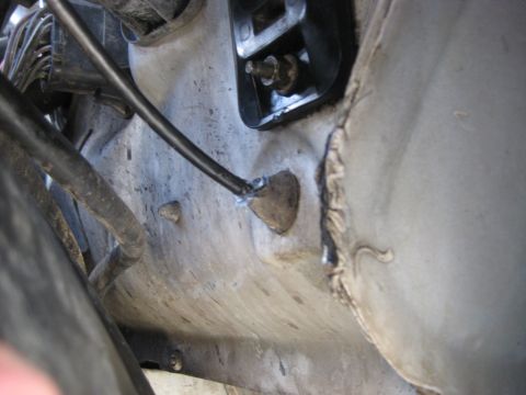 1994 Ford Bronco - Undercarriage view of a vehicle, showing various mechanical components and wiring. The Supermotors.net logo is present in the corner.