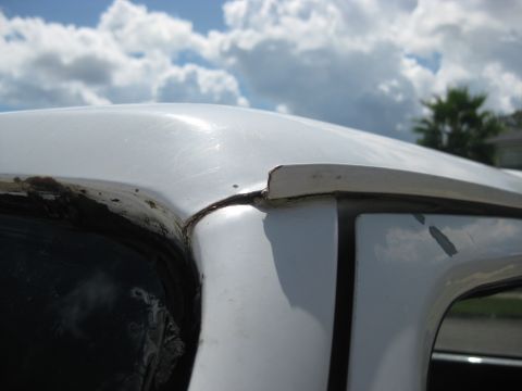 1994 Ford Bronco - Close-up of the interior roofline and window frame of a 1994 Ford Bronco.