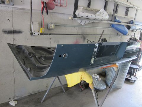 1991 Ford LTD Crown Victoria - A car door is propped up on sawhorses in a workshop setting.