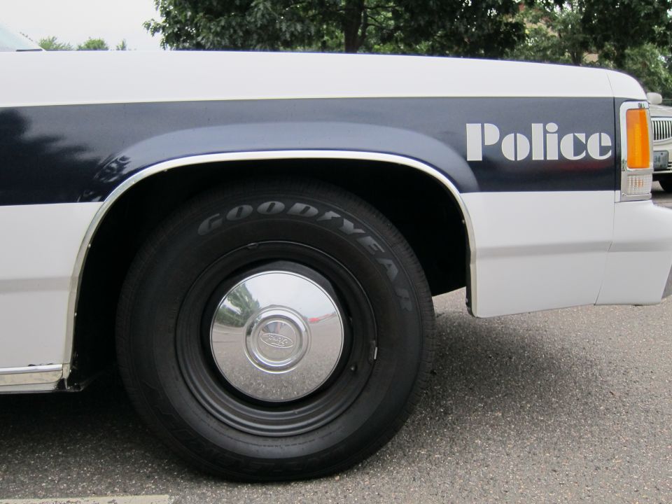 Side view of a 1991 Ford Crown Victoria police car fender with 'Police' text