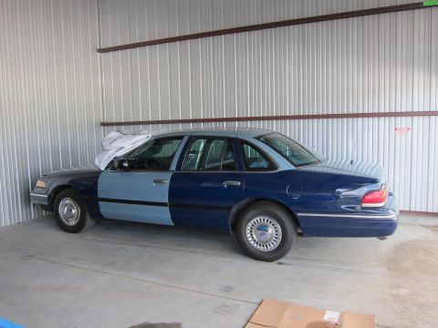 1991 Ford LTD Crown Victoria - This sedan has two different paint colors on its body panels, with the front half a lighter blue and the rear half a darker blue.