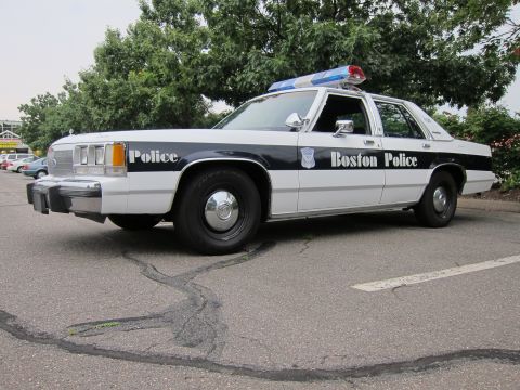 1991 Ford LTD Crown Victoria - Boston Police car, a 1991 Ford Crown Victoria LTD, parked on asphalt with trees in the background.