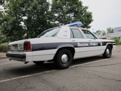 1991 Ford LTD Crown Victoria - Boston Police Crown Victoria, likely a 1991 model, parked in a lot.