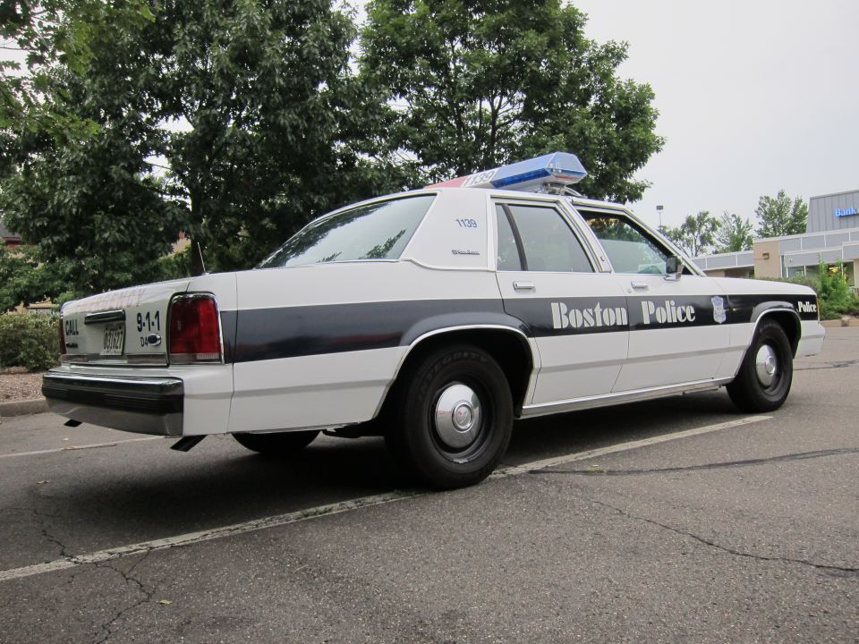 1991 Ford Crown Victoria LTD police car with 'Boston Police' on the door and a light bar on the roof