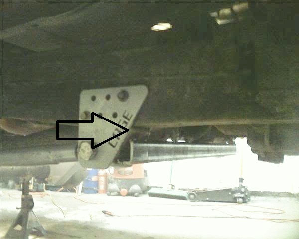 Undercarriage bracket labeled "CAGE" with arrow pointing to it