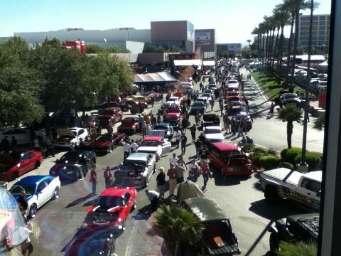 1990 Ford Bronco - A large gathering of vehicles and spectators are present at an outdoor event.
