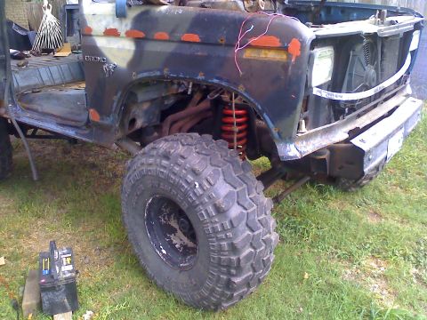 1990 Ford Bronco - This Ford Bronco shows significant off-road modifications and custom camouflage paint.