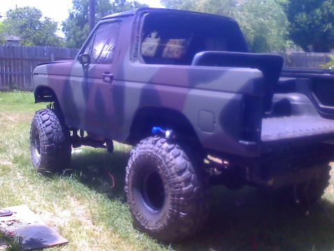 1990 Ford Bronco - This lifted Ford Bronco is painted in a camouflage pattern and sits on large, aggressive tires.