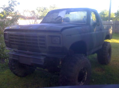 1990 Ford Bronco - This lifted truck features a prominent aftermarket grille and oversized tires, suggesting a custom build.
