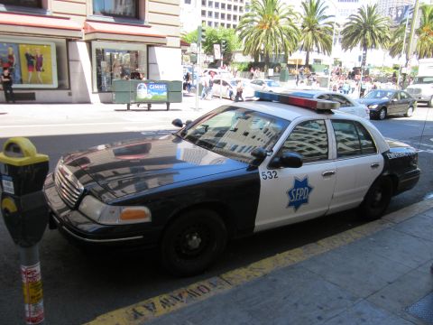 1991 Ford LTD Crown Victoria - A San Francisco Police Department car is parked curbside on a sunny day in the city.