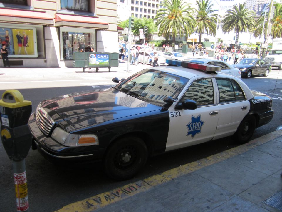 SFPD police car parked on street, 3q-front view