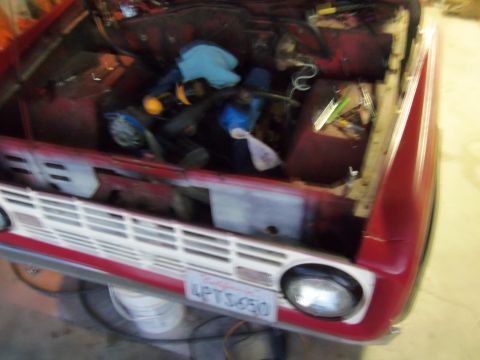 1968 Ford Bronco - Engine bay of a 1968 Ford Bronco, showing tools and components.