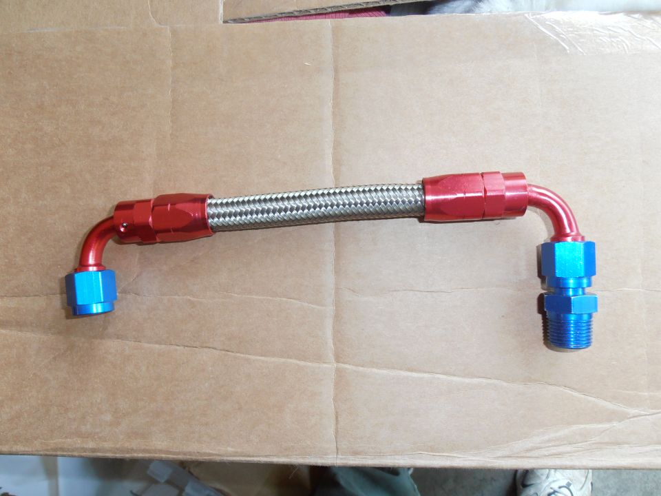 Braided fuel line with red anodized fittings and blue AN connectors