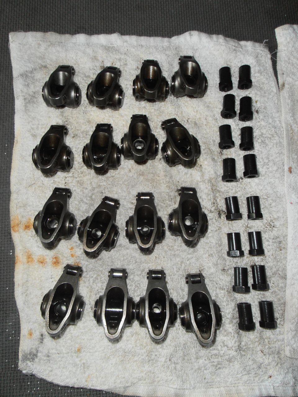 Engine rocker arms and pushrods laid out on a white cloth