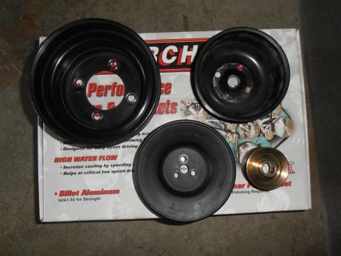 1990 Ford Bronco - Set of water pump pulleys, including one brass pulley, displayed on their product packaging.