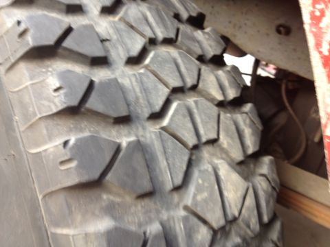 1984 Ford Bronco - Close-up of aggressive off-road tire tread pattern.