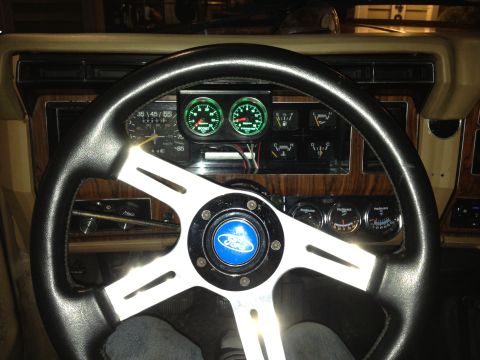 1984 Ford Bronco - Interior view of a vehicle's dashboard, showing a steering wheel and various gauges.