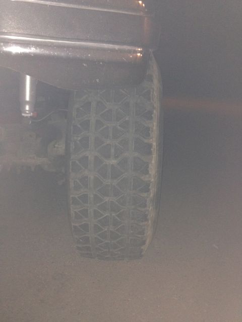 1984 Ford Bronco - The rear tire and fender of a 1984 Ford Bronco are visible in this side view.