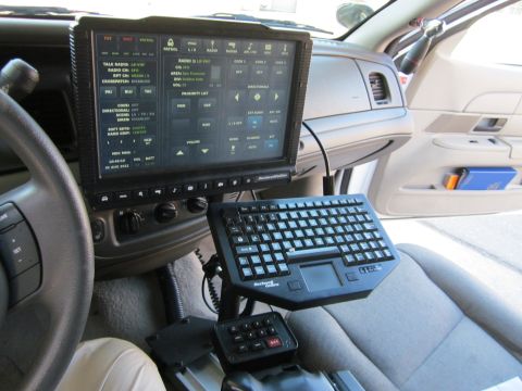 1991 Ford LTD Crown Victoria - Police car interior equipped with a computer system and keyboard, likely for dispatch and communication.