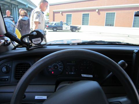 1991 Ford LTD Crown Victoria - View from inside a police car, showing the dashboard and a glimpse of another police vehicle outside.