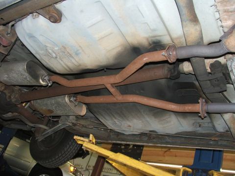 1988 Ford Crown Victoria LTD - Undercarriage view showing the exhaust system and fuel tank, with some rust visible.