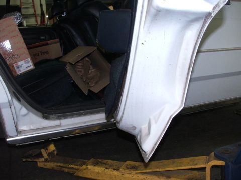 1988 Ford Crown Victoria LTD - The interior of a car is shown with the driver's side door open, revealing boxes and the seats.