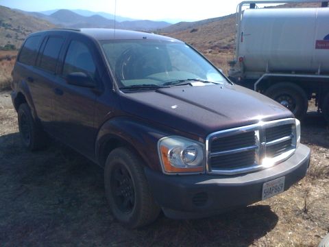 1968 Ford Mustang - This Dodge Durango SUV is parked outdoors next to a large water tank truck.