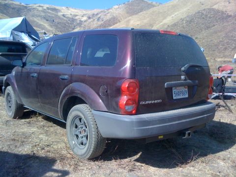 1968 Ford Mustang - Rear view of a purple Dodge Durango SUV parked in a dry, outdoor setting with mountains behind it.