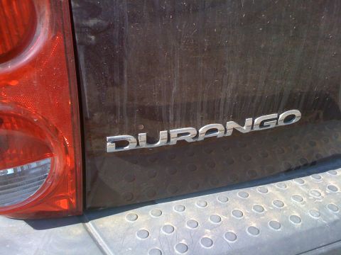 1968 Ford Mustang - The rear of a dark-colored SUV displays the 'DURANGO' nameplate, with a portion of the taillight visible on the left.