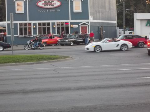 1970 Ford Ranchero - A variety of vehicles are visible on the street in front of a restaurant.