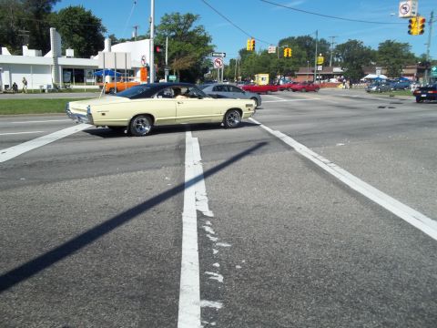1970 Ford Ranchero - A 1969 Mercury Cougar XR7 convertible turns at an intersection on a sunny day.