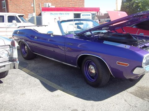 1970 Ford Ranchero - A purple convertible muscle car is parked outdoors with its hood up, next to other vehicles.