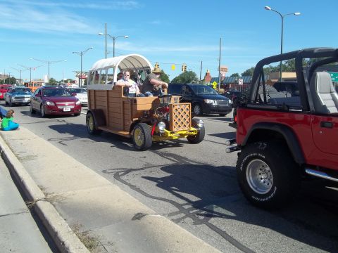 1970 Ford Ranchero - A unique wooden vehicle with a covered passenger area is seen in traffic.