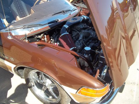 1970 Ford Ranchero - Custom engine bay features aftermarket air intake and chrome wheels.