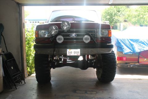1990 Ford Bronco - Front view of a 1990 Ford Bronco with auxiliary lights and a custom bumper.