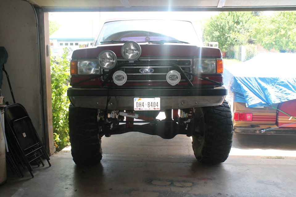 1990 Ford Bronco front view with four Hella lights mounted on a bar above the grille
