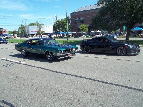 1970 Ford Ranchero - A 1970 Ford Ranchero and a modern Nissan GT-R cruise down the street on a sunny day.