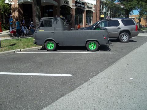 1970 Ford Ranchero - Gray 1961 Ford Econoline pickup truck with bright green wheels is parked on asphalt.