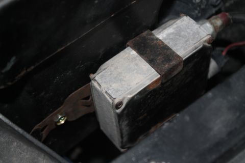 1990 Ford Bronco - A close-up view of an automotive electrical component, possibly a relay or solenoid, showing signs of age and wear.
