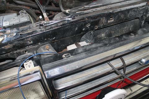 1990 Ford Bronco - Close-up of the front grille and engine bay of a 1990 Ford Bronco.