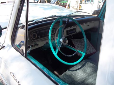 1970 Ford Ranchero - The interior of a classic truck features a turquoise steering wheel and matching trim accents.