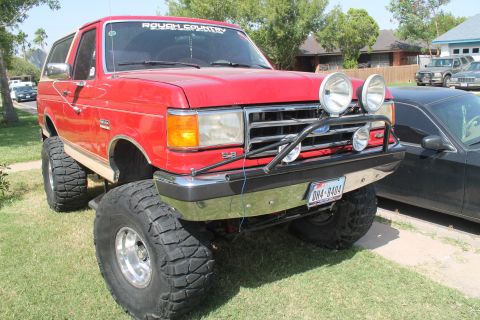 1990 Ford Bronco - This lifted 1990 Ford Bronco features off-road lights and a "Rough Country" banner on the windshield.