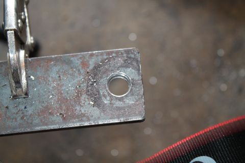 1990 Ford Bronco - A metal bracket with a threaded hole is secured by a clamp, with the Supermotors logo in the corner.