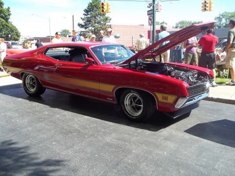 1970 Ford Ranchero - A red 1970 Ford Ranchero is displayed with its hood open, showing the engine bay.