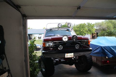 1990 Ford Bronco - This lifted 1990 Ford Bronco features a light bar and multiple auxiliary lights mounted on the front.