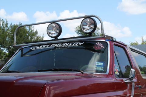 1990 Ford Bronco - This Ford Bronco has a custom light bar mounted on its roof rack, two large spotlights.