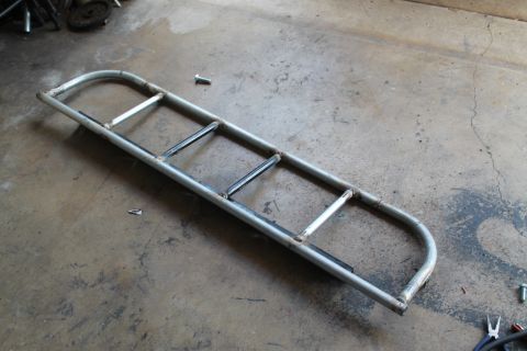 1990 Ford Bronco - A custom metal light cage is shown on a concrete surface, with visible welds and mounting points.