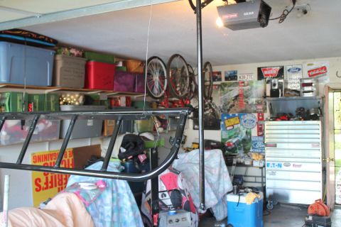 1990 Ford Bronco - Garage scene with storage, tools, and various posters on the wall.