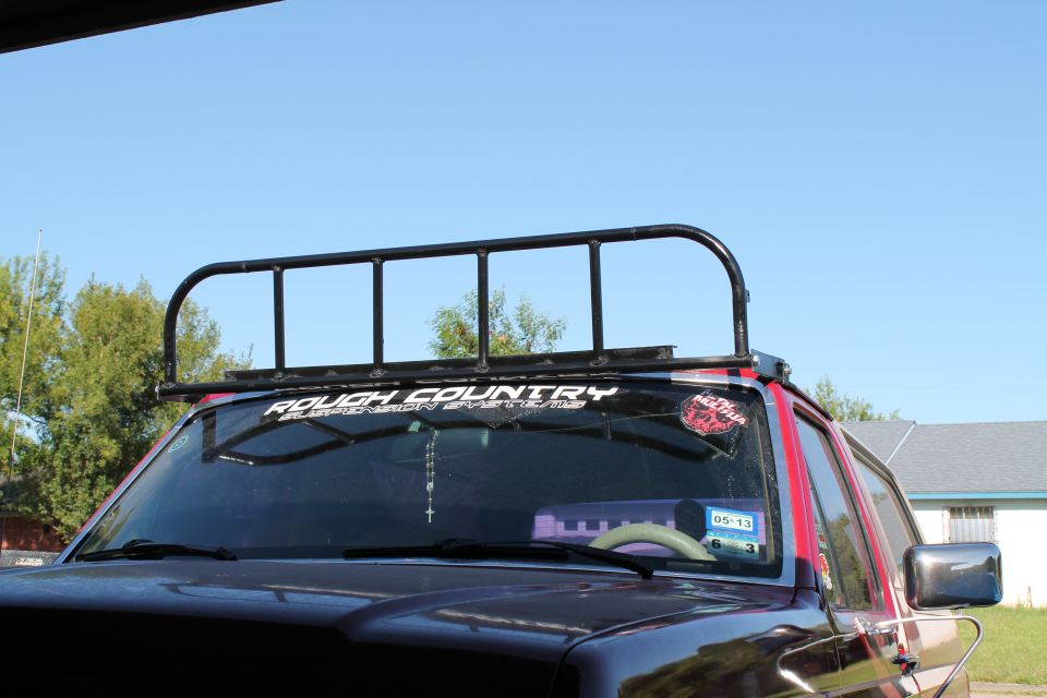 SUV front with roof rack, "ROUGH COUNTRY" sticker on windshield